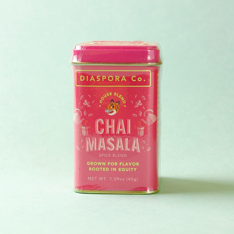 Pink canister of Diaspora Co. Chai Masala spice blend on a light green background