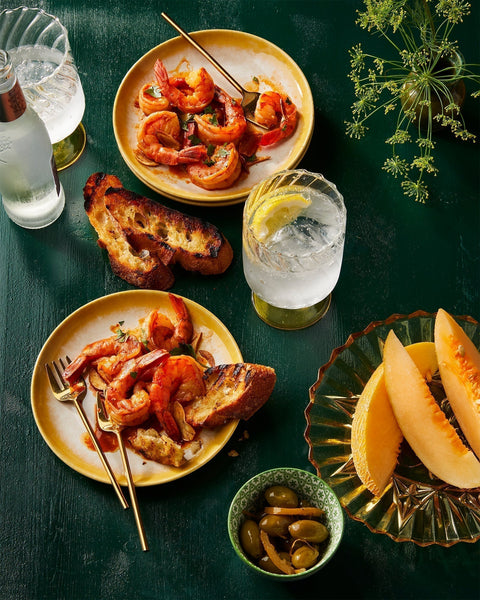 Smoky Spanish shrimp with garlic and sherry vinegar, served on plates with crusty bread