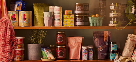 Image of Bianco di Napoli canned tomatoes, harissa, dukkah, Thai Curry paste, tonka beans, Kitten & the Bear Jam, Salted & Co Cocktail Nuts, Chestnut Flour, Chuck Hughes Pepper Sauce, Furikake, Sweetopolita Sprinkles and Panengeli Italian Leavener on a Shelf