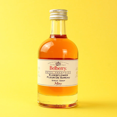 Bottle of Belberry Elderflower syrup on a yellow background