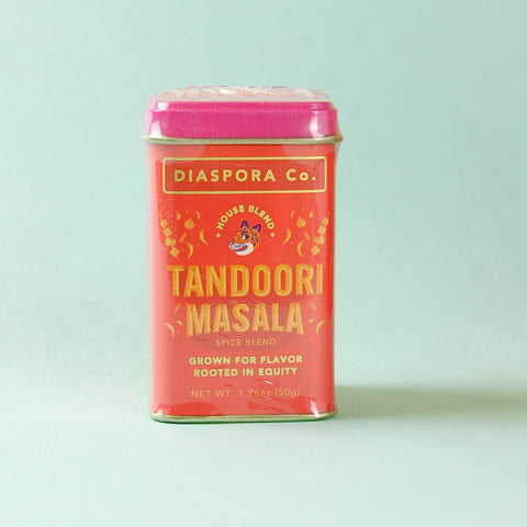 Diaspora Co Tandoori Masala tin on light blue background