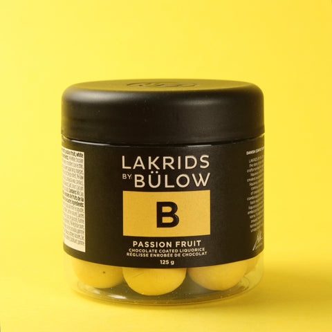 Jar of Lakrids by Bülow passion fruit chocolate licorice on a yellow background
