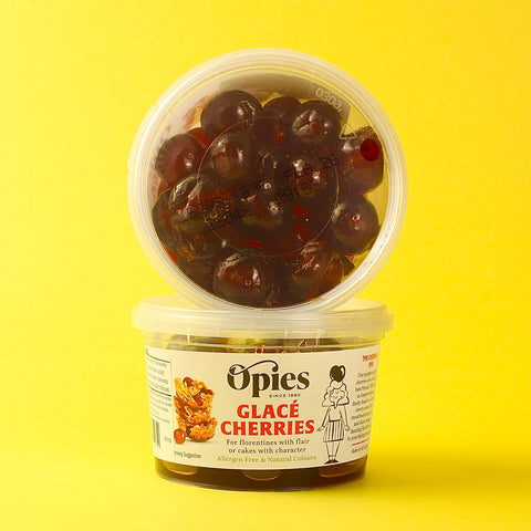 Opies Glace Cherries container on a yellow background